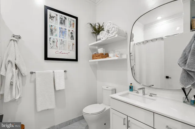 a bedroom with a bed and a couch next to a window