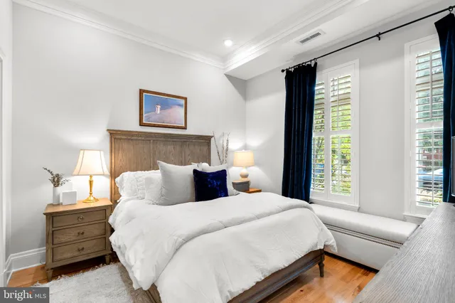 a bedroom with a large bed and a flat tv screen