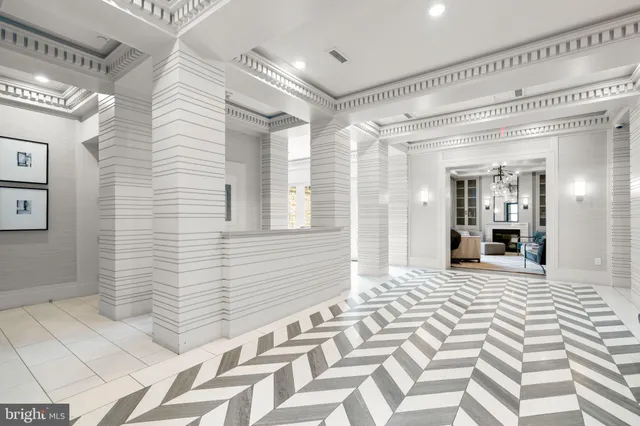a view of a hallway with wooden floor and a bathroom
