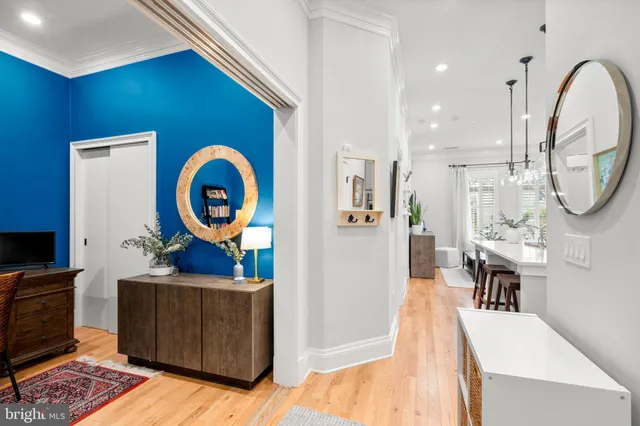 a living room with furniture a mirror and a clock