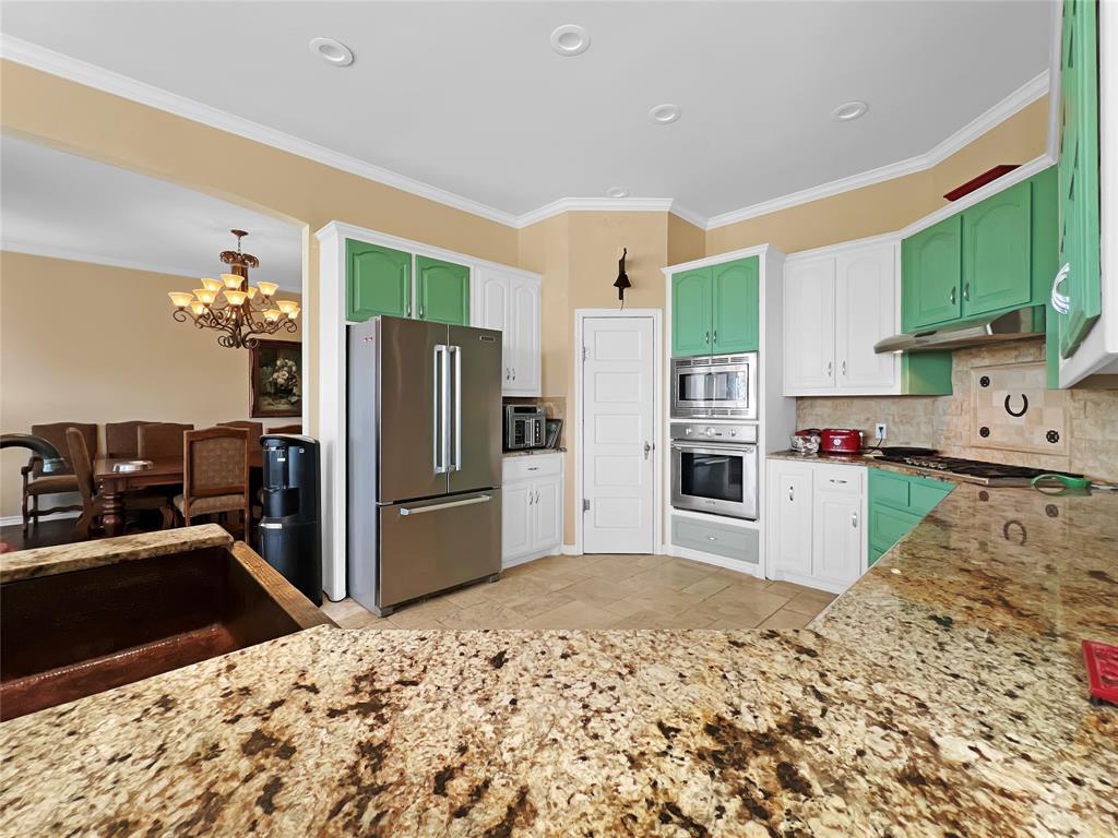 590 County Road 385 Valley View, TX 76272 - Photo 11 of 38 a kitchen with stainless steel appliances kitchen island granite countertop a refrigerator and a sink