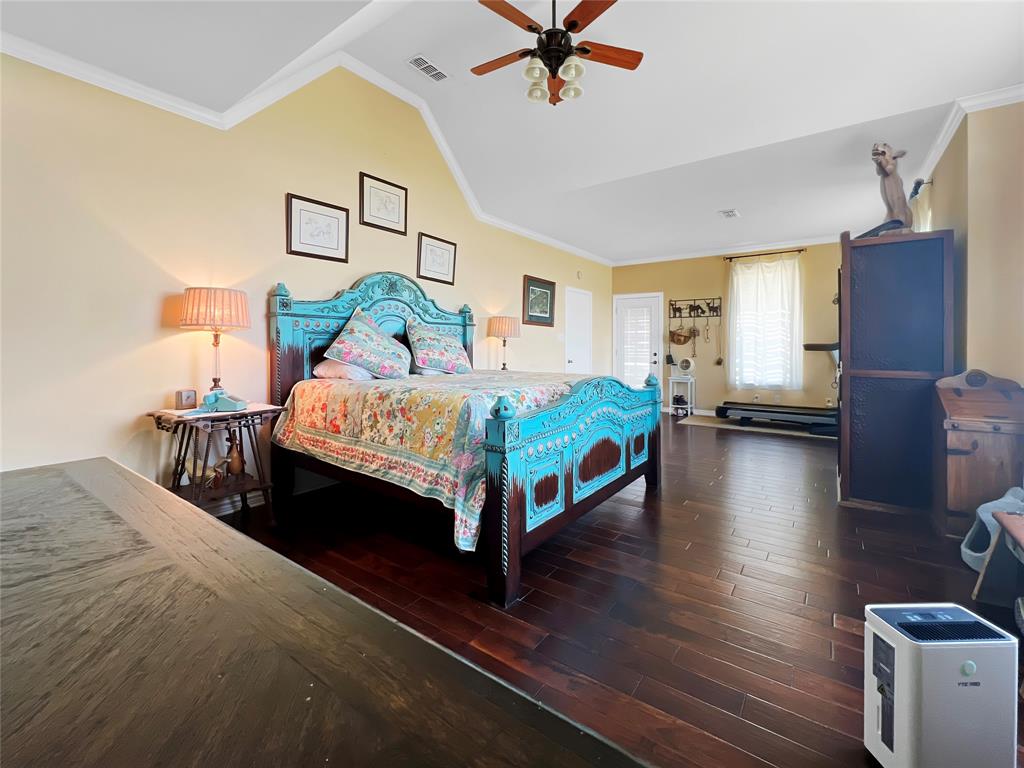 590 County Road 385 Valley View, TX 76272 - Photo 16 of 38 a bedroom with a bed and ceiling fan