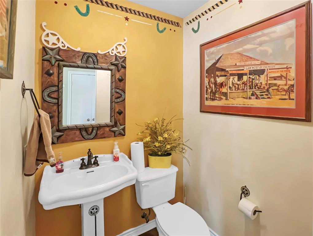 590 County Road 385 Valley View, TX 76272 - Photo 22 of 38 a bathroom with a sink mirror and toilet