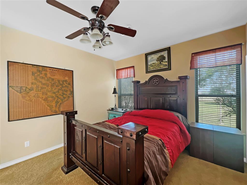 590 County Road 385 Valley View, TX 76272 - Photo 23 of 38 a bedroom with a bed and a chandelier