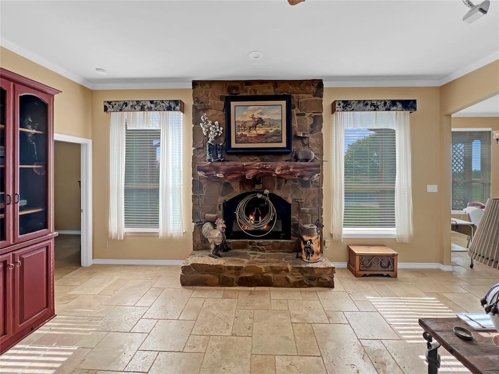 590 County Road 385 Valley View, TX 76272 - Photo 4 of 38 a living room with furniture a window and a fireplace