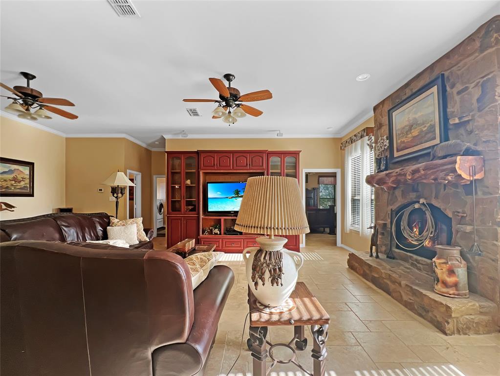 590 County Road 385 Valley View, TX 76272 - Photo 5 of 38 a living room with furniture a fireplace and a flat screen tv