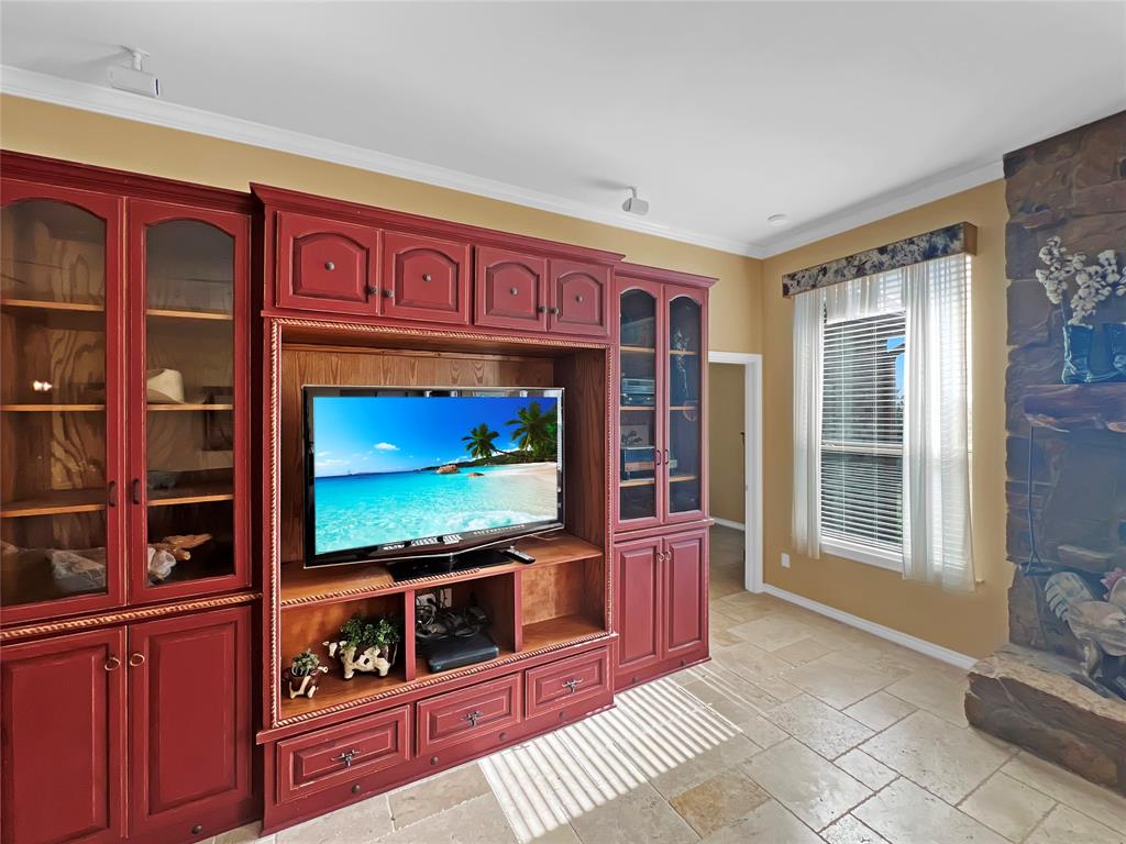 590 County Road 385 Valley View, TX 76272 - Photo 8 of 38 a living room with furniture a flat screen tv and floor to ceiling window