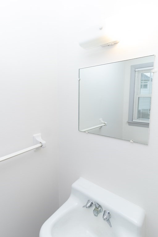 205-207 Nottingham Street Springfield, MA 01104 - Photo 8 of 25 a bathroom with a sink and a mirror