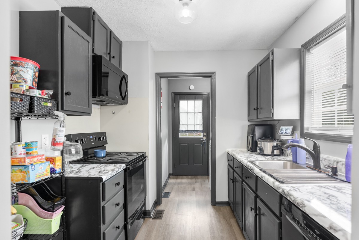 560 Gregory Road Westmoreland, TN 37186 - Photo 20 of 41 a kitchen with stainless steel appliances granite countertop a sink stove and refrigerator