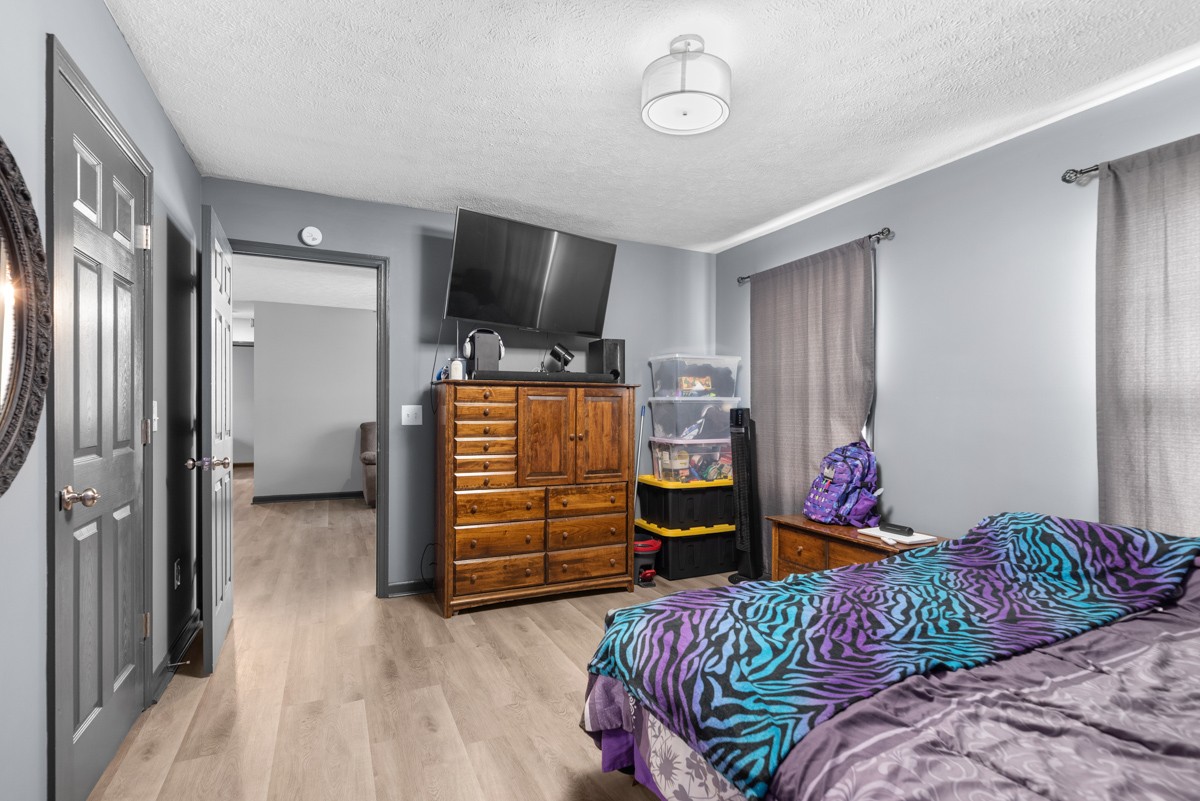 560 Gregory Road Westmoreland, TN 37186 - Photo 25 of 41 a bedroom with a bed and flat screen tv