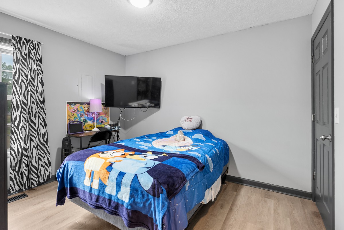 560 Gregory Road Westmoreland, TN 37186 - Photo 28 of 41 a bedroom with a bed a flat screen tv and a window