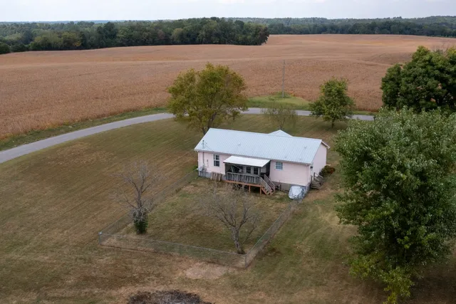 an aerial view of a house with outdoor space and lake view