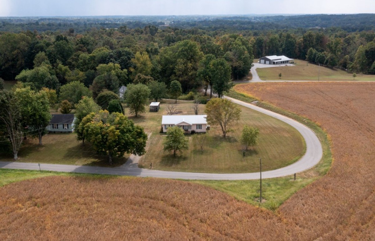 560 Gregory Road Westmoreland, TN 37186 - Photo 7 of 41 an aerial view of a house with a yard and large trees