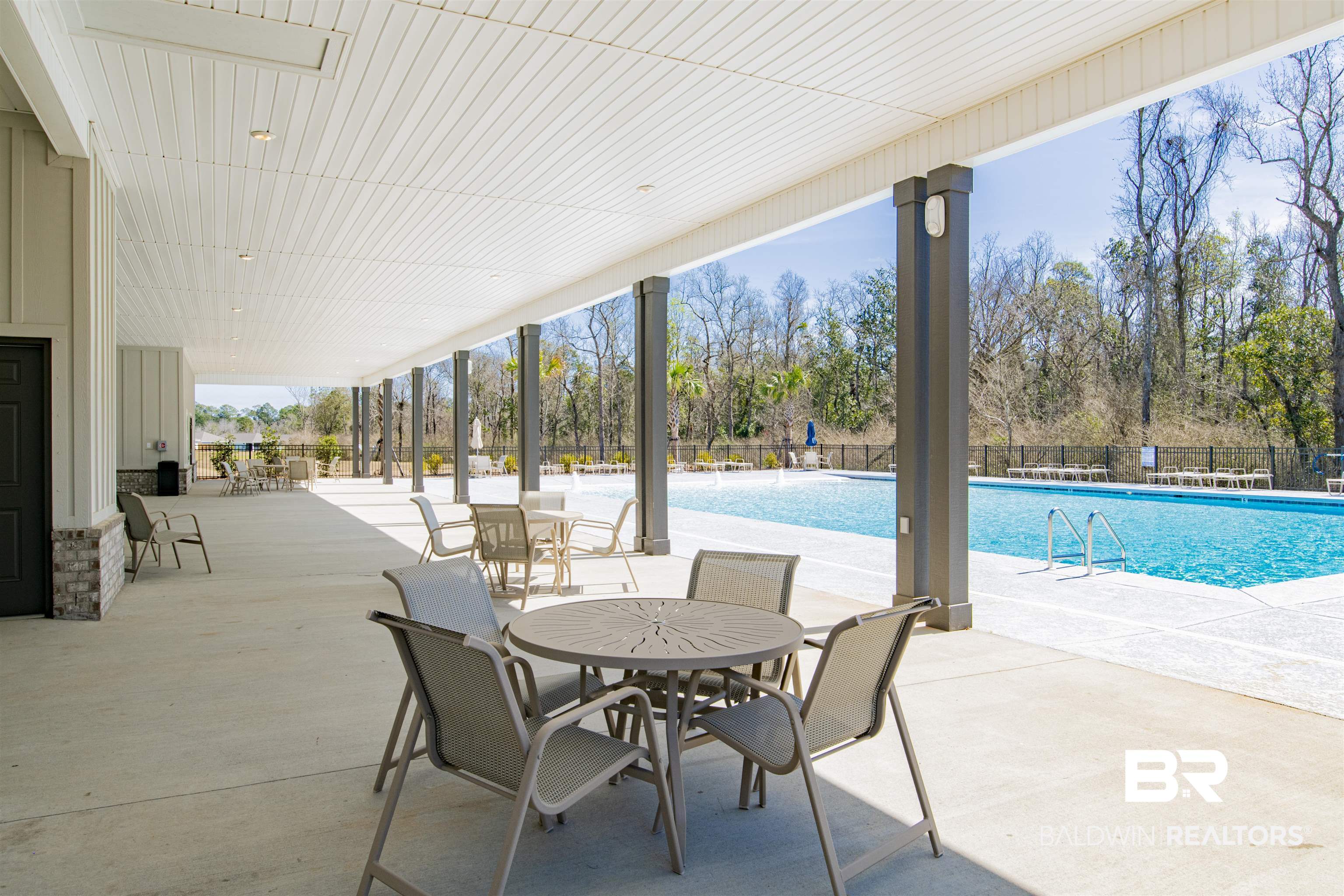 22301 Early Dawn Circle Foley, AL 36535 - Photo 41 of 45 Expansive covered patio featuring a slatted white ceiling, recessed lighting, and support columns