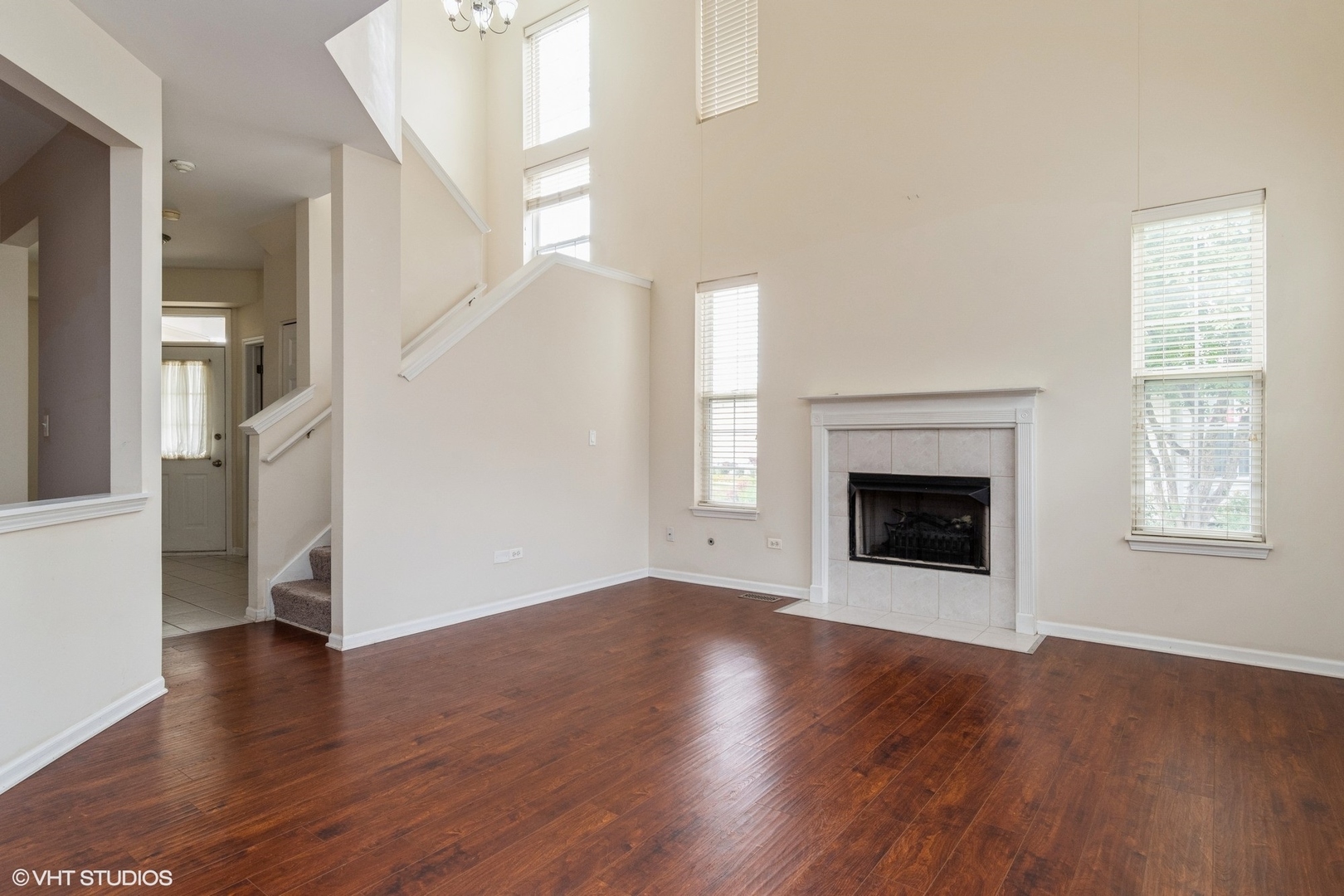 2966 White Thorn Circle Naperville, IL 60564 - Photo 3 of 15 a view of a livingroom with wooden floor a fireplace and windows