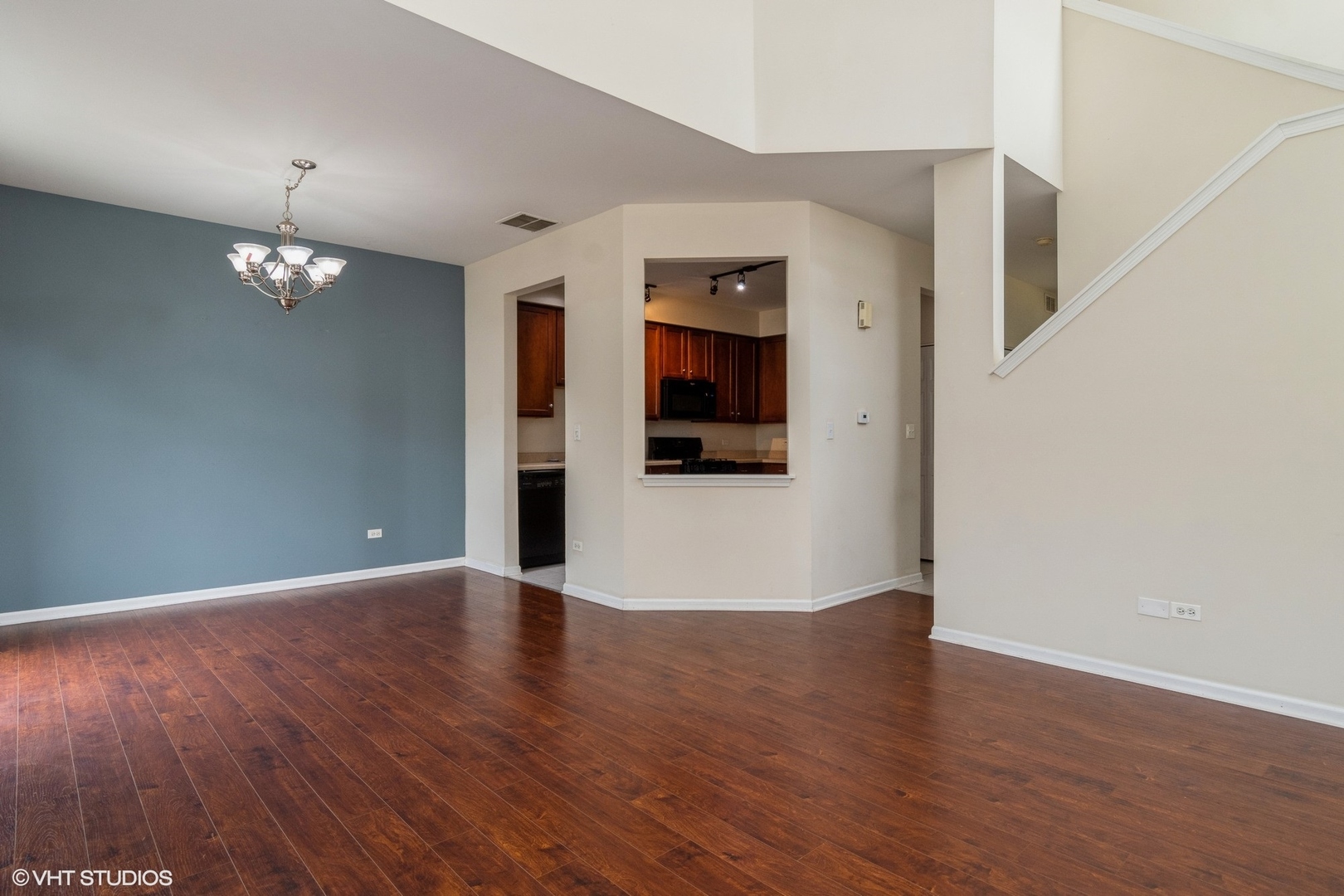 2966 White Thorn Circle Naperville, IL 60564 - Photo 7 of 15 a view of a hallway with wooden floor and chandelier