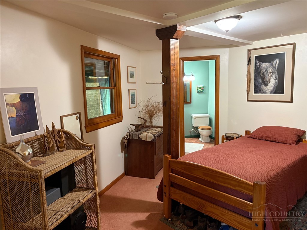 873 Silverleaf Road Zionville, NC 28698 - Photo 32 of 49 a bedroom with a bed and wooden floor