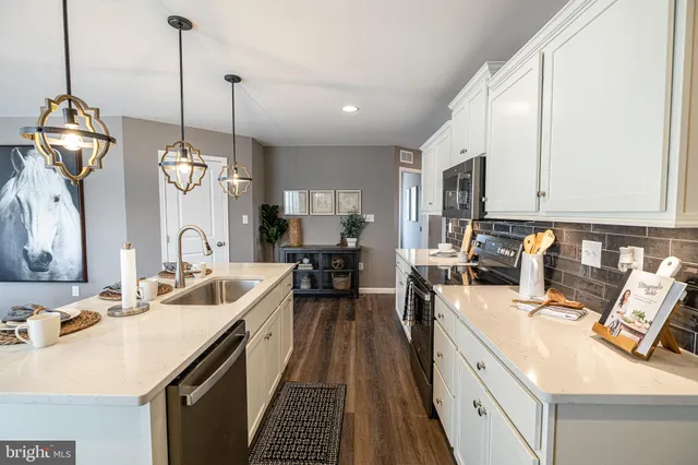 a large kitchen with kitchen island a large center island attached withe living room