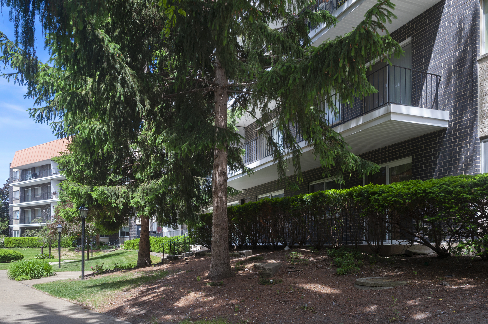 4949 Golf Road, Unit 101 Skokie, IL 60077 - Photo 20 of 22 a view of a street with a building and trees in the background