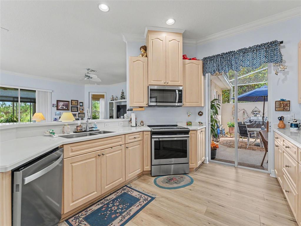 8910 Jericho Road Weeki Wachee, FL 34613 - Photo 26 of 52 a kitchen with a sink stove and cabinets