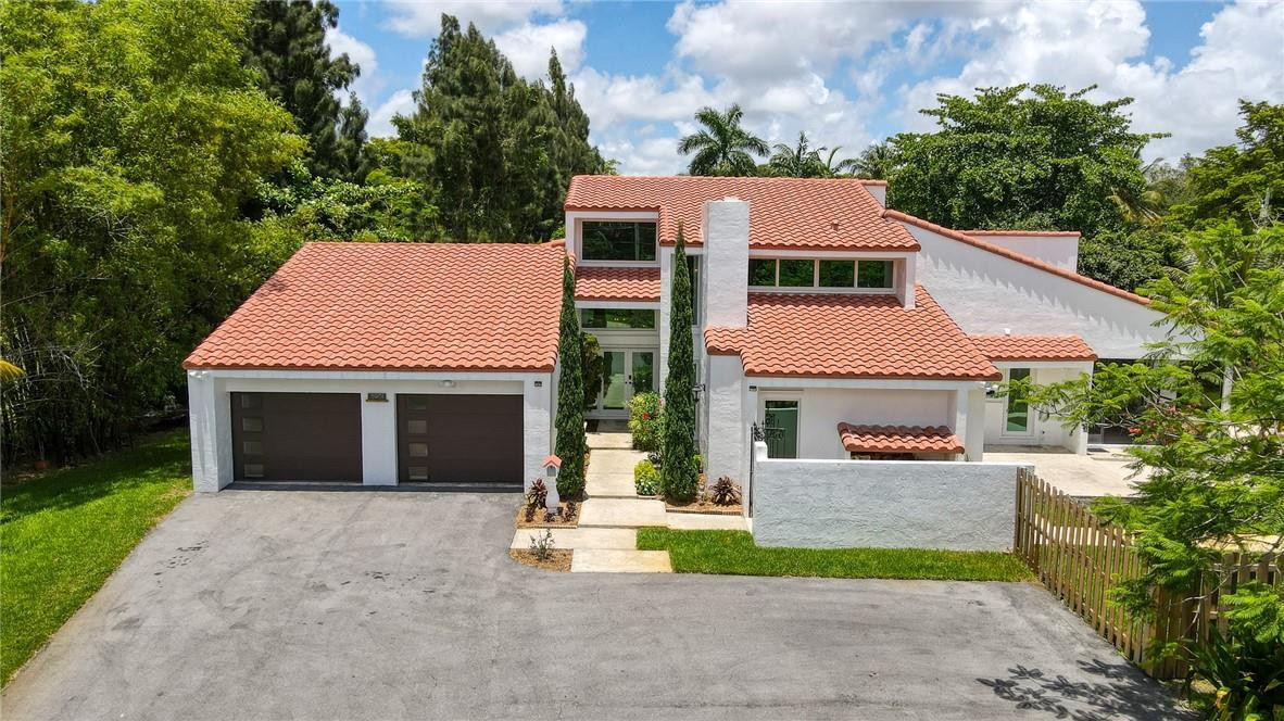 a aerial view of a house with a yard and potted plants