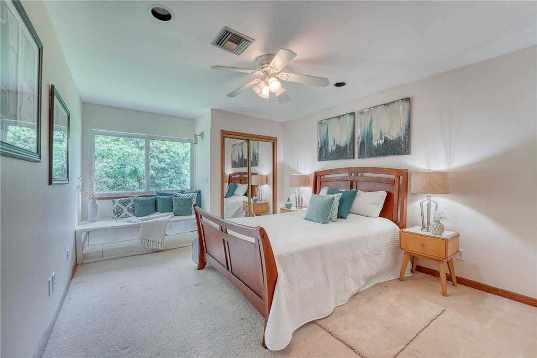 5901 Cypress Road Plantation, FL 33317 - Photo 14 of 99 a bedroom with a large bed and a chandelier fan