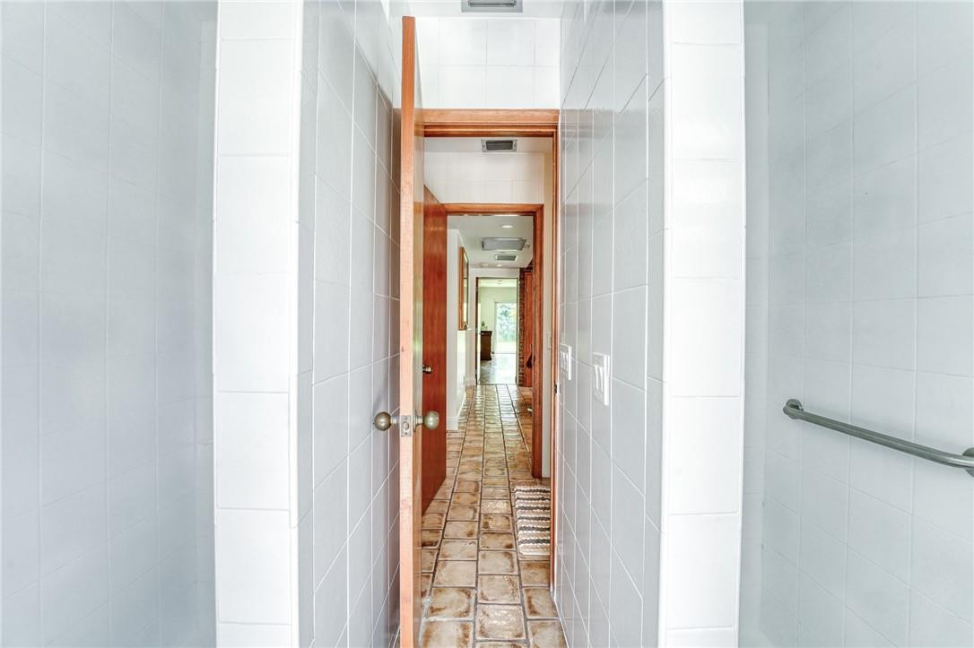 5901 Cypress Road Plantation, FL 33317 - Photo 42 of 99 a view of a bathroom from a corridor