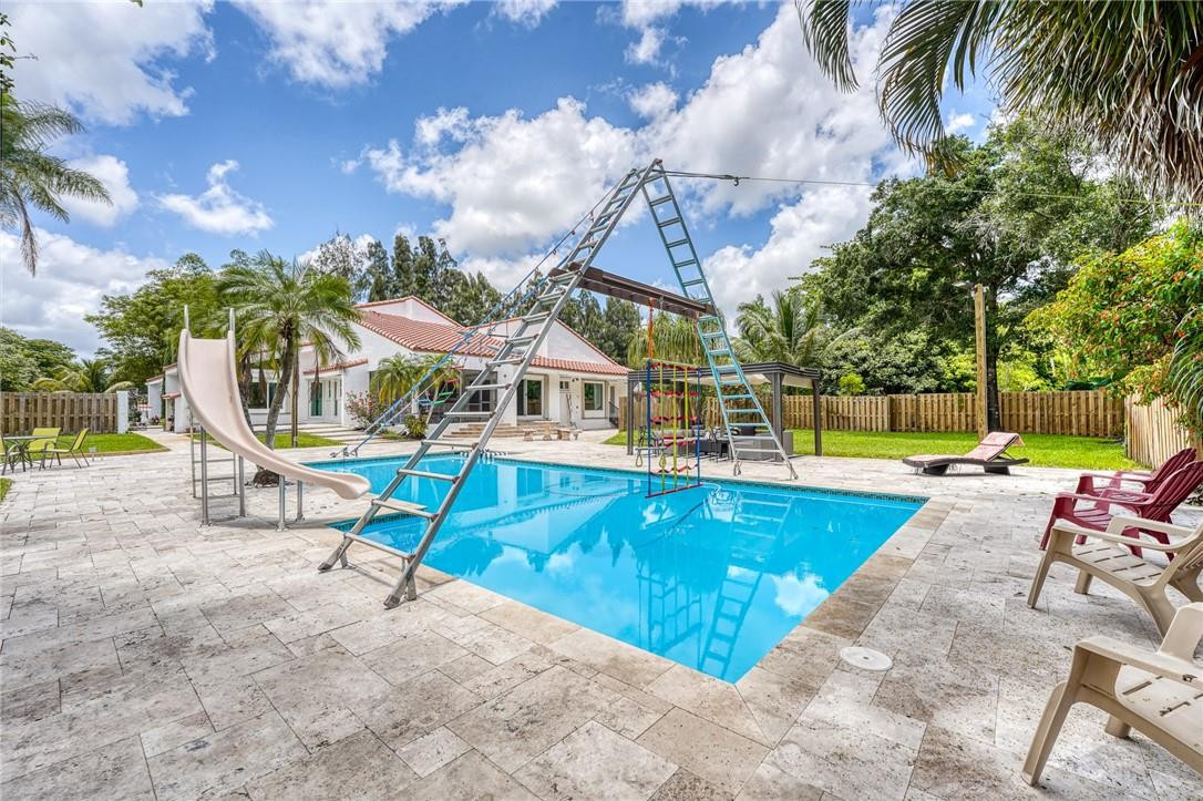 5901 Cypress Road Plantation, FL 33317 - Photo 74 of 99 a view of a swimming pool with a lounge chair