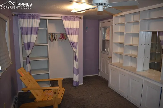 a view of walk in closet with empty racks