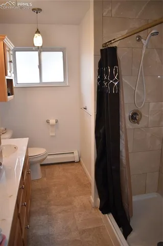 a bathroom with a shower and a toilet