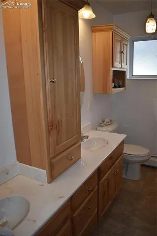 a bathroom with a sink a toilet and mirror
