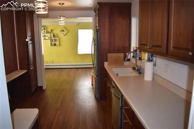 a kitchen with sink refrigerator and microwave