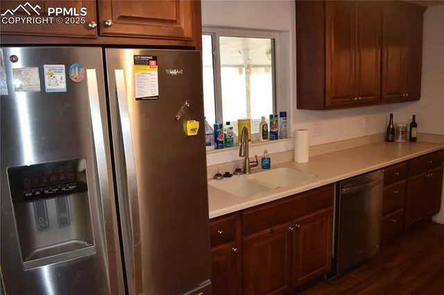 a kitchen with a sink and refrigerator