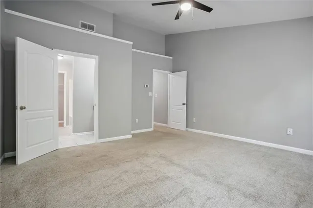 an empty room with a empty space and a ceiling fan