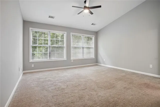 an empty room with a empty space and windows