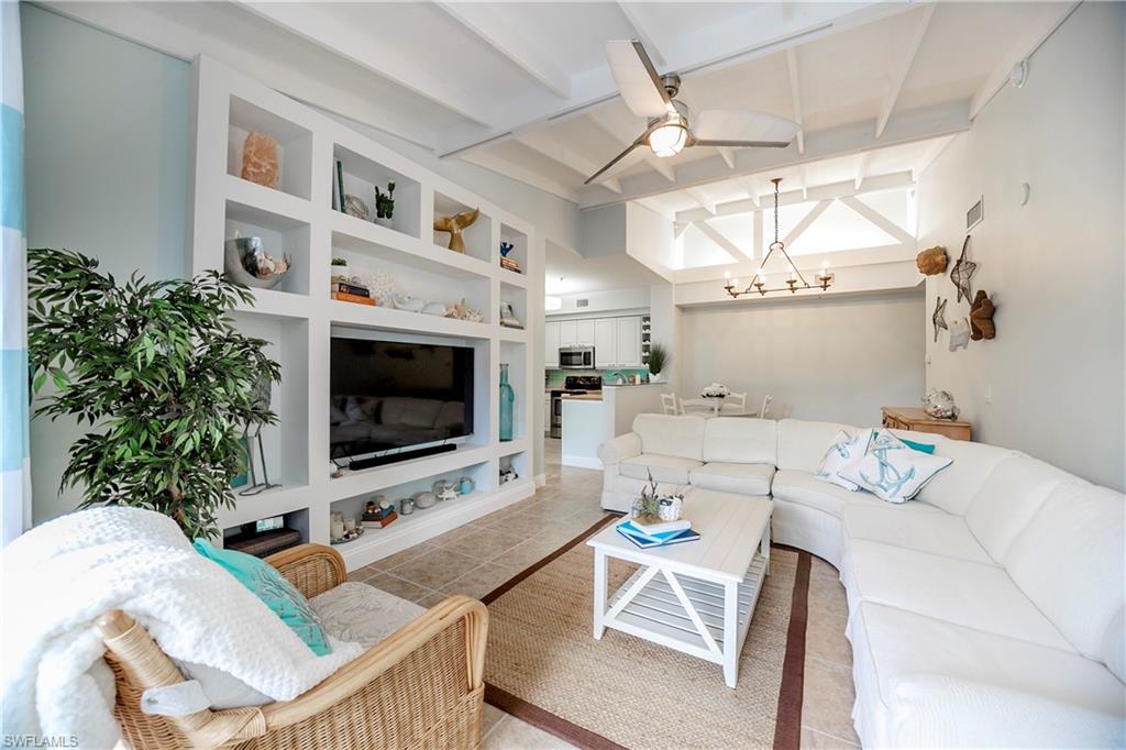 1160 Reserve Way, Unit 303 Naples, FL 34105 - Photo 1 of 19 a living room with furniture and a flat screen tv