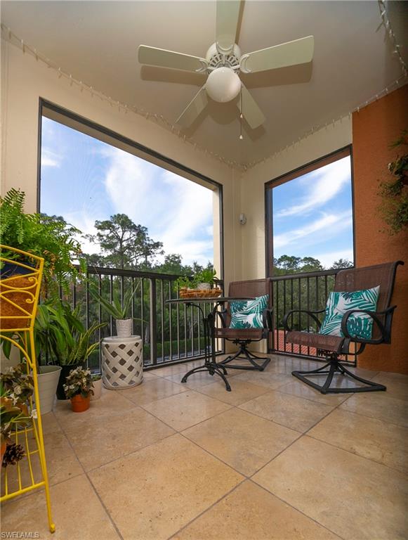 1160 Reserve Way, Unit 303 Naples, FL 34105 - Photo 12 of 19 a view of a swimming pool and couches in a patio