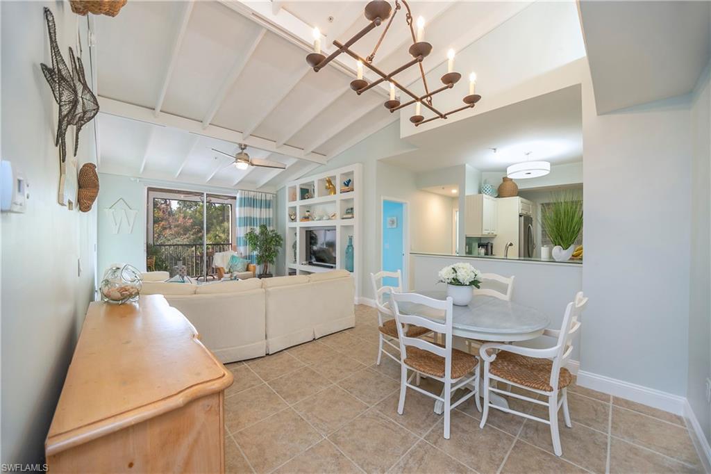 1160 Reserve Way, Unit 303 Naples, FL 34105 - Photo 3 of 19 a dining room with wooden floor and furniture