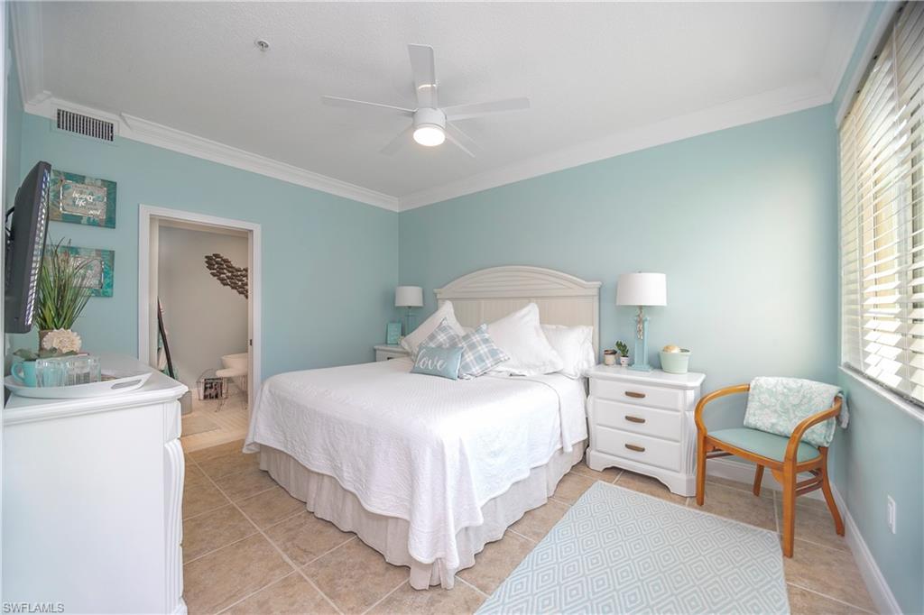 1160 Reserve Way, Unit 303 Naples, FL 34105 - Photo 4 of 19 a bedroom with a bed and a table