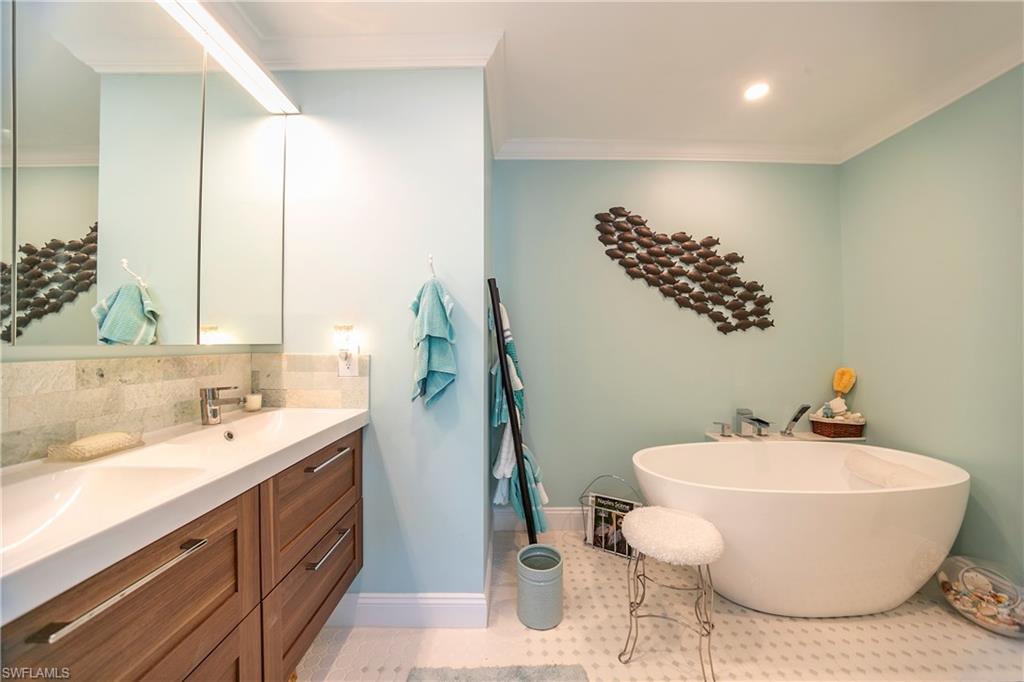 1160 Reserve Way, Unit 303 Naples, FL 34105 - Photo 6 of 19 a bathroom with a sink and mirror
