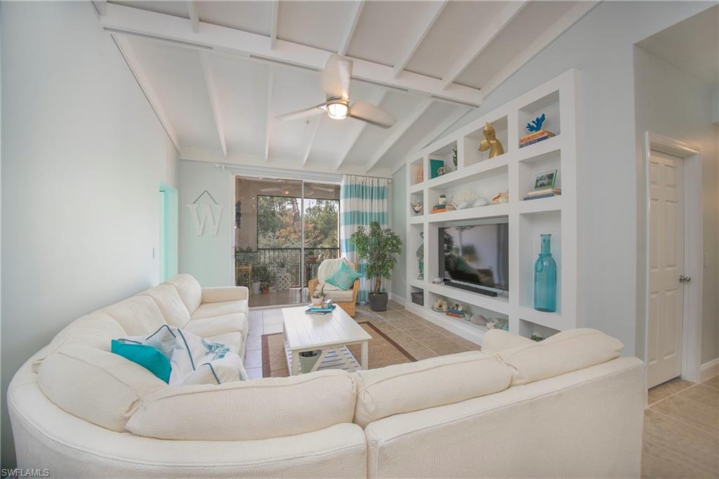 1160 Reserve Way, Unit 303 Naples, FL 34105 - Photo 8 of 19 a living room with furniture and a flat screen tv