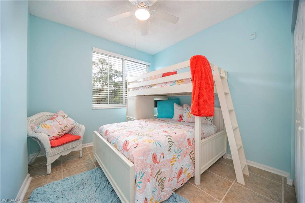 1160 Reserve Way, Unit 303 Naples, FL 34105 - Photo 10 of 19 a bedroom with a bed and a window