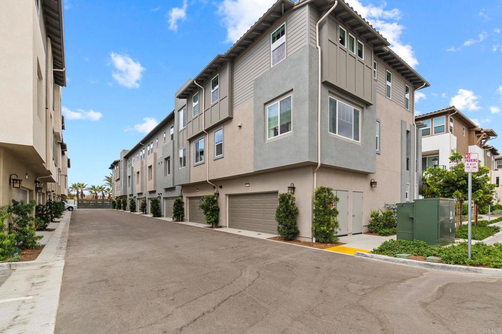 13018 Lumen Way San Diego, CA 92130 - Photo 35 of 45 a view of a white house with a yard