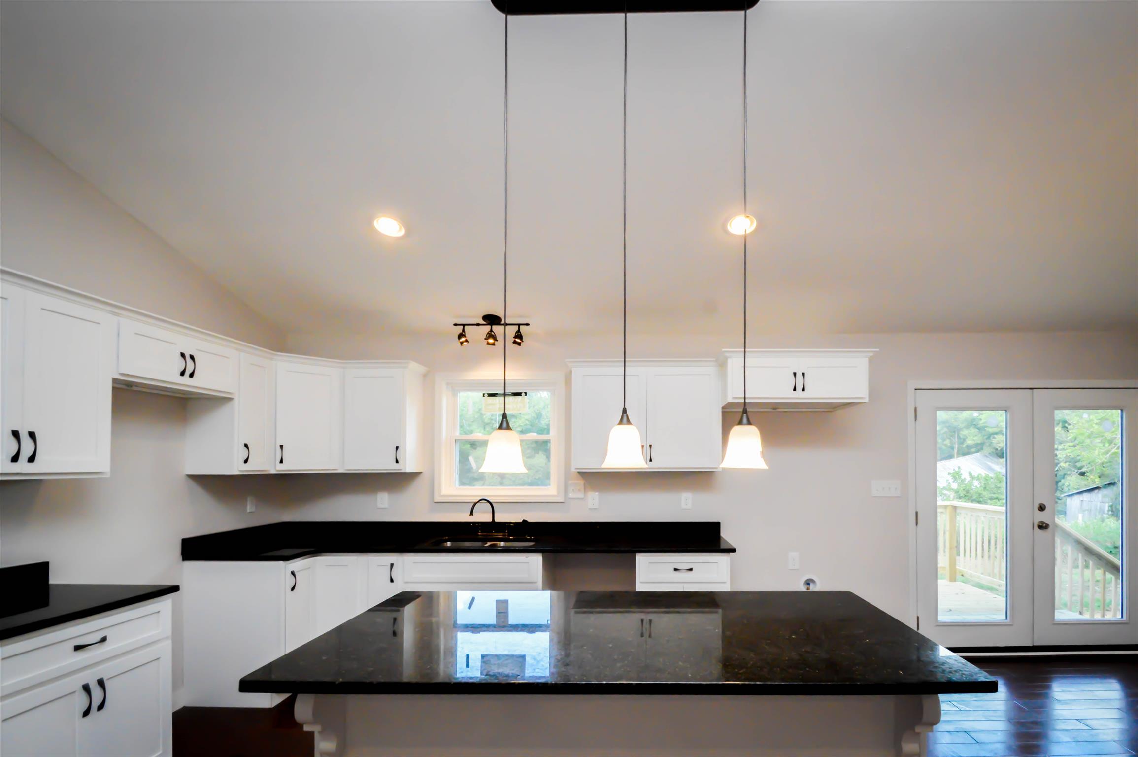 30 Riddleton Circle Pleasant Shade, TN 37145 - Photo 7 of 18 a kitchen with stainless steel appliances granite countertop a sink a stove and a wooden floors