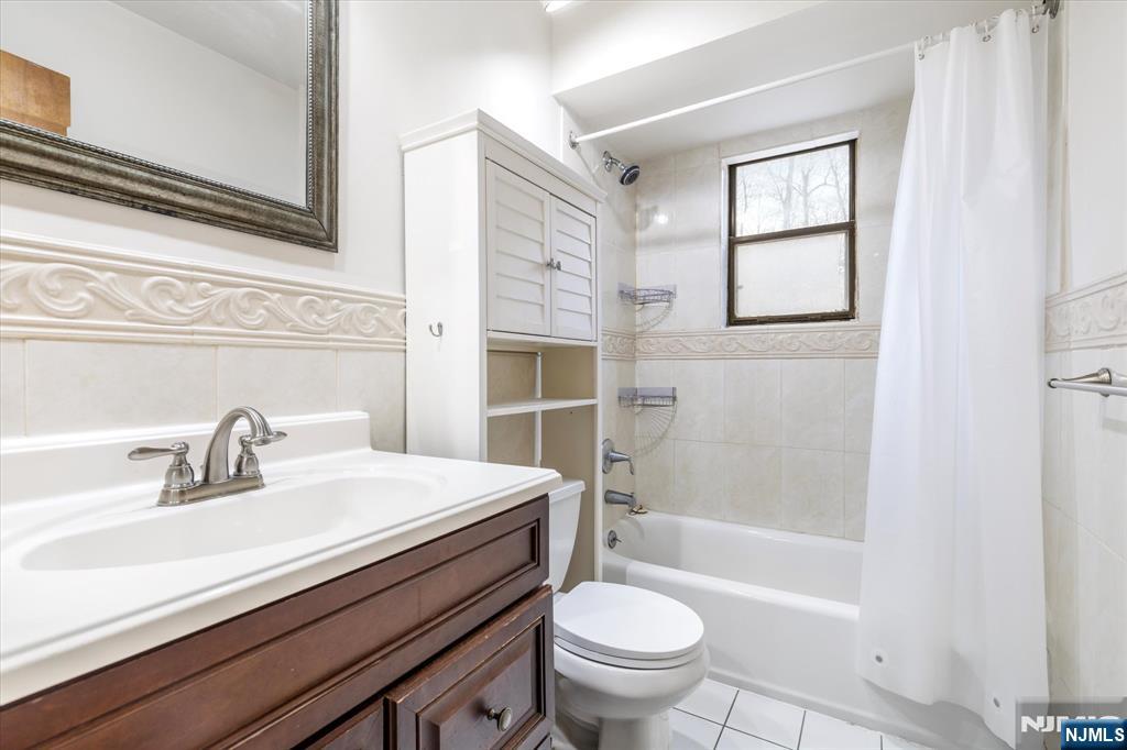 70 Orient Way, Unit 9 Rutherford, NJ 07070 - Photo 11 of 16 a bathroom with a sink a toilet and shower