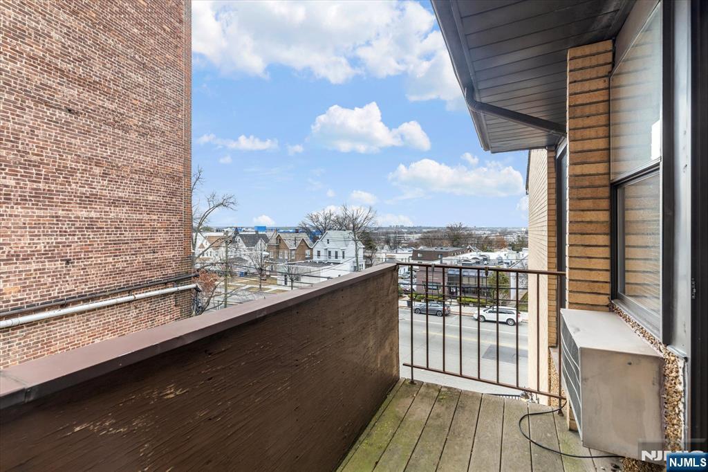 70 Orient Way, Unit 9 Rutherford, NJ 07070 - Photo 13 of 16 a view of a balcony with a floor to ceiling window and wooden floor
