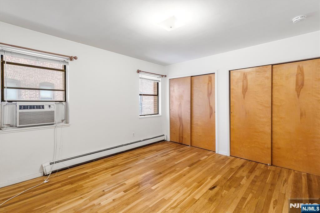 70 Orient Way, Unit 9 Rutherford, NJ 07070 - Photo 10 of 16 an empty room with wooden floor and windows
