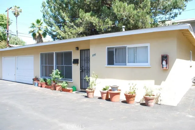 a backyard of a house with table and chairs