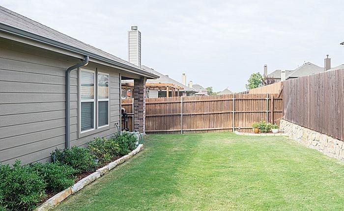 1513 Rosson Road Little Elm, TX 75068 - Photo 17 of 17 a view of a backyard with a garden and deck