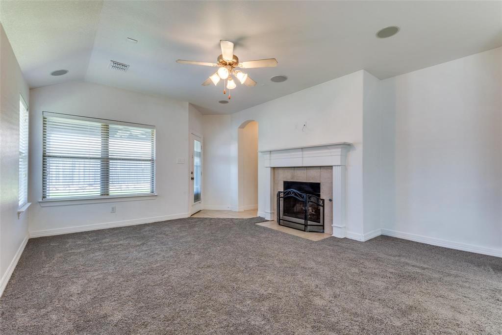 1513 Rosson Road Little Elm, TX 75068 - Photo 8 of 17 an empty room with windows and fireplace